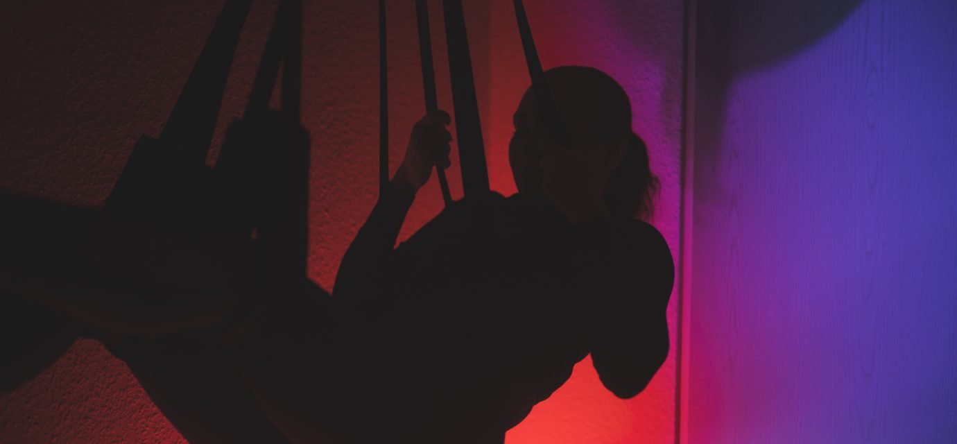 Swingers Club - low-angle-view-silhouette-woman-standing-against-orange-sky