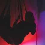 Swingers Club - low-angle-view-silhouette-woman-standing-against-orange-sky