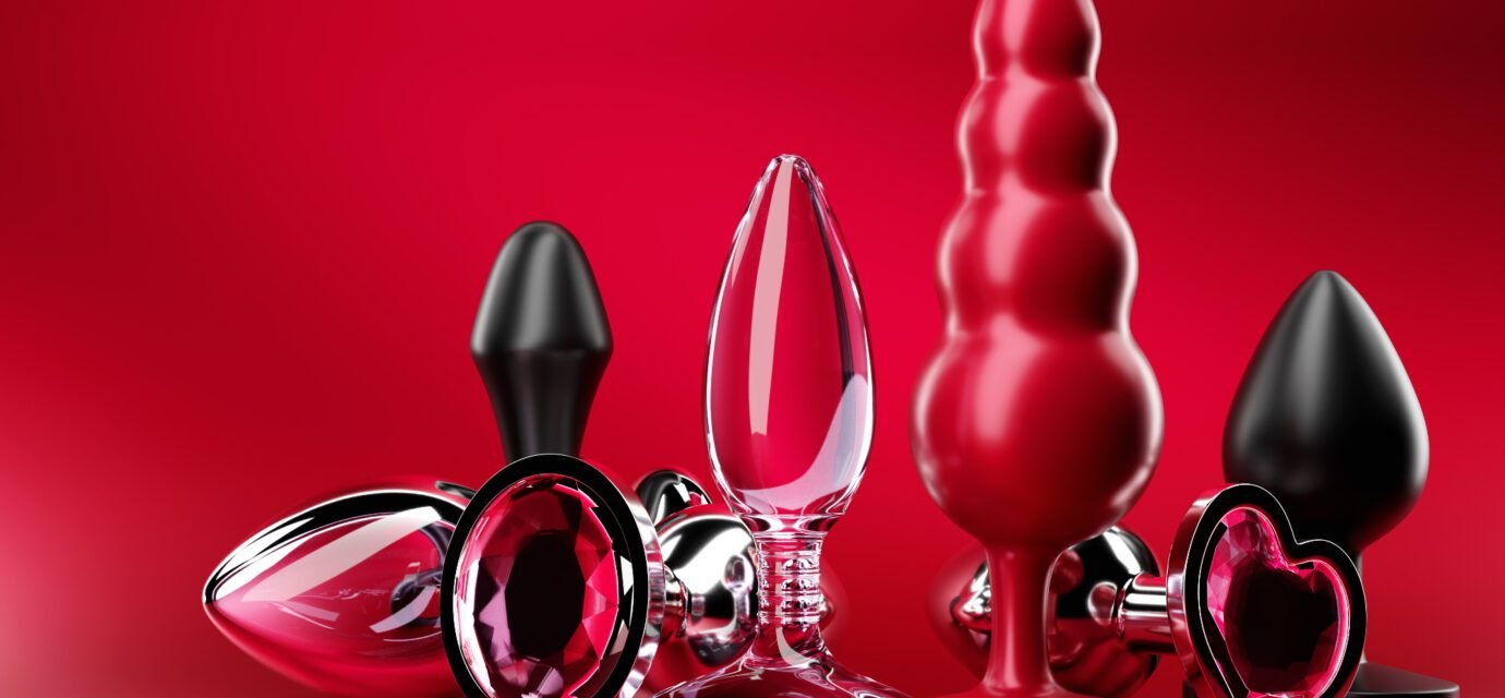 Black butt anal plugs sex toys on magenta isolated background. 3D illustration. Empty space for your text