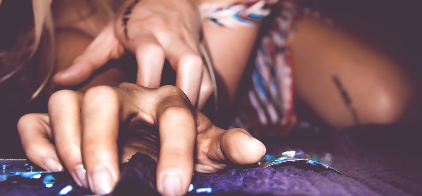 Swingers Club - close-up-woman-using-smart-phone-bed