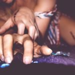 Swingers Club - close-up-woman-using-smart-phone-bed