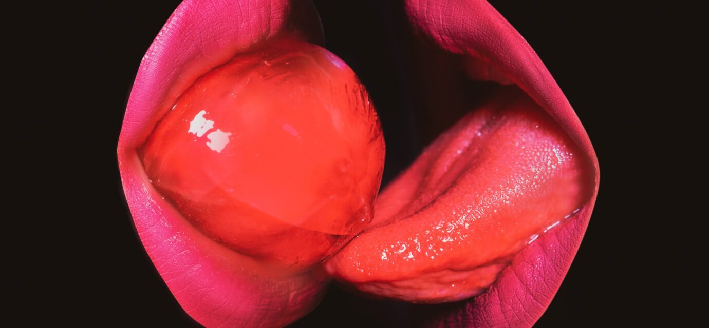 Closeup women suck and lick red lollipop. Lgbt, lgbtq banner. Kissing through lollipop.