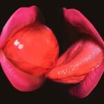 Closeup women suck and lick red lollipop. Lgbt, lgbtq banner. Kissing through lollipop.