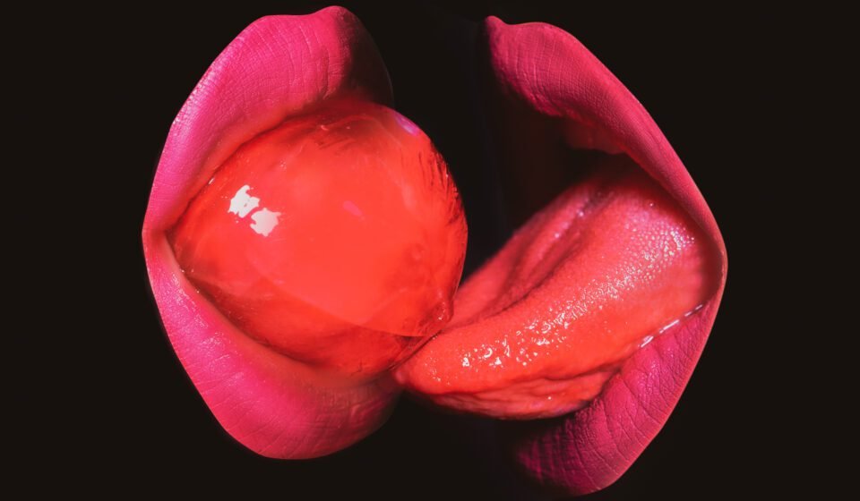 Closeup women suck and lick red lollipop. Lgbt, lgbtq banner. Kissing through lollipop.