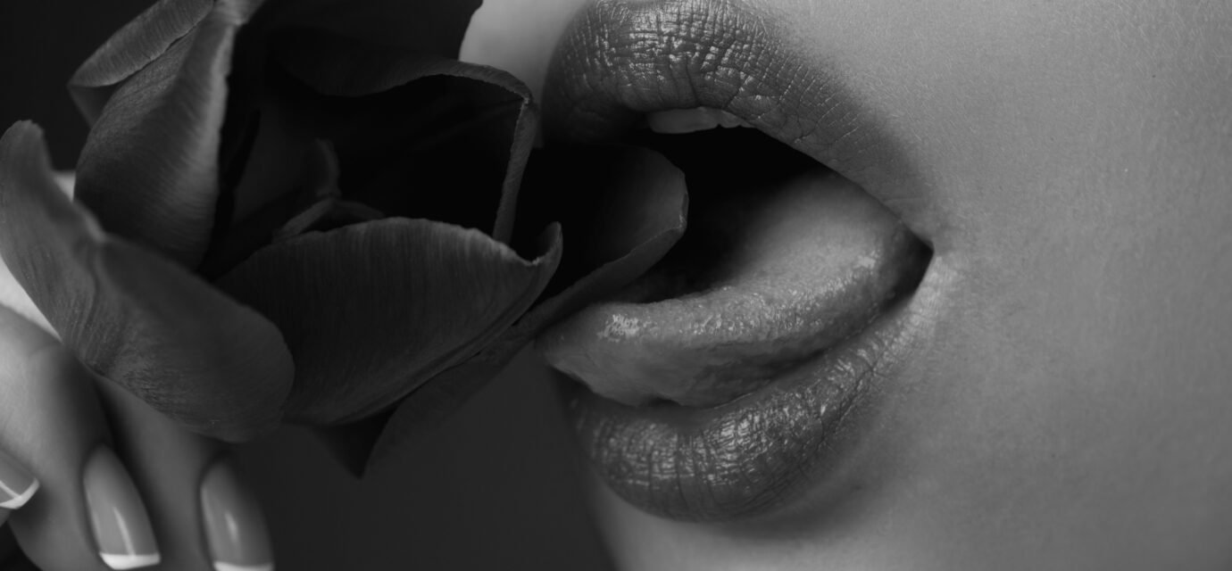Licking lips. Woman mouth with sexy lips licking tongue flower. Mouth lick and suck close up. Beauty natural lips. Sensual licking, open sexy mouth. Sexy lick with tongue concept. Girl licking tulip.